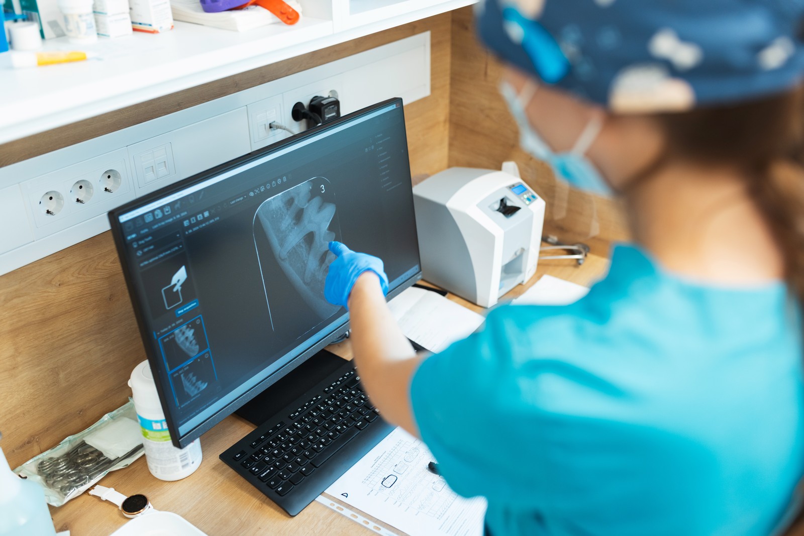 Veterinarian reviewing dental X-ray on monitor