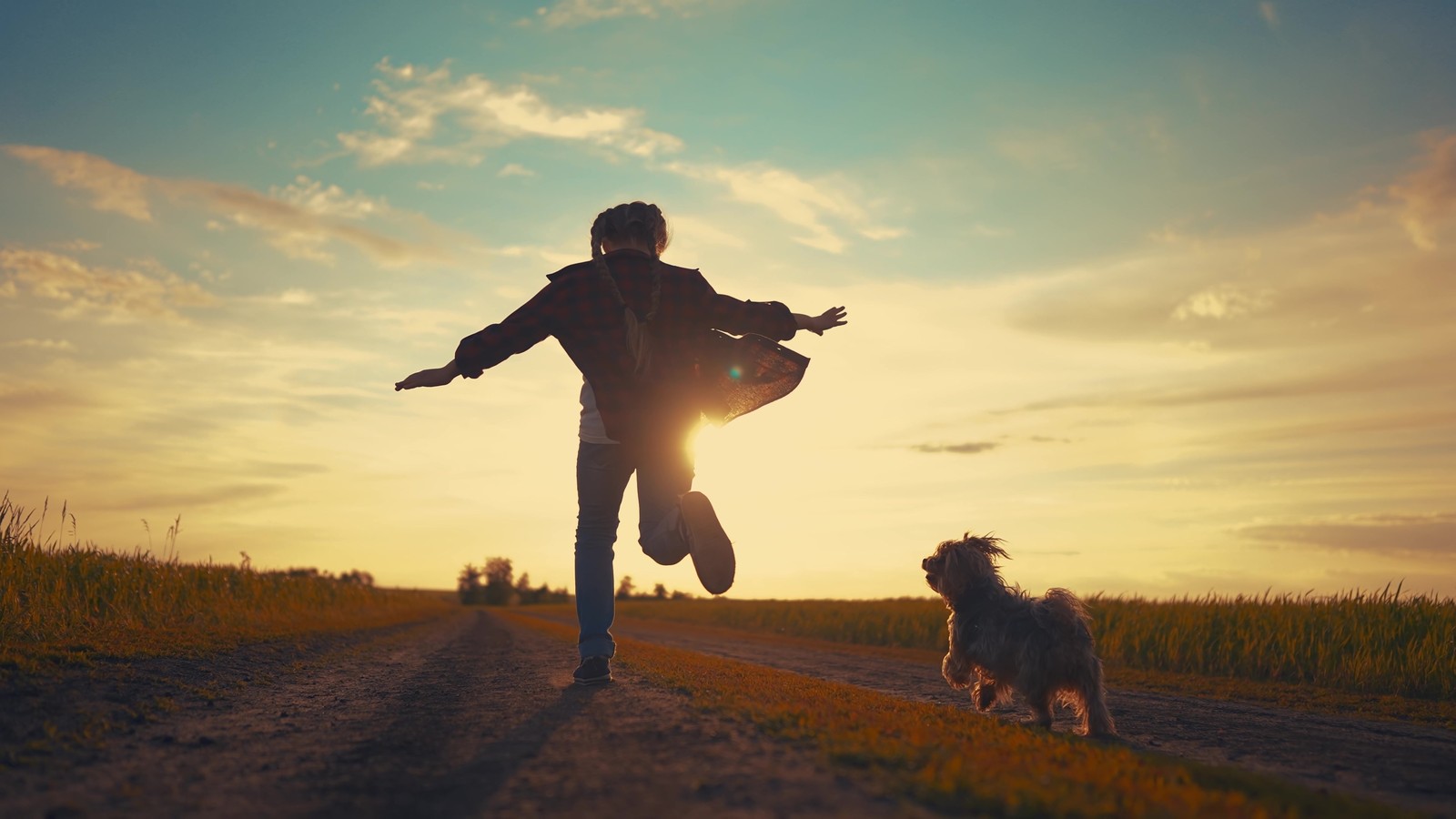 Person and dog running free at sunset — a second chance